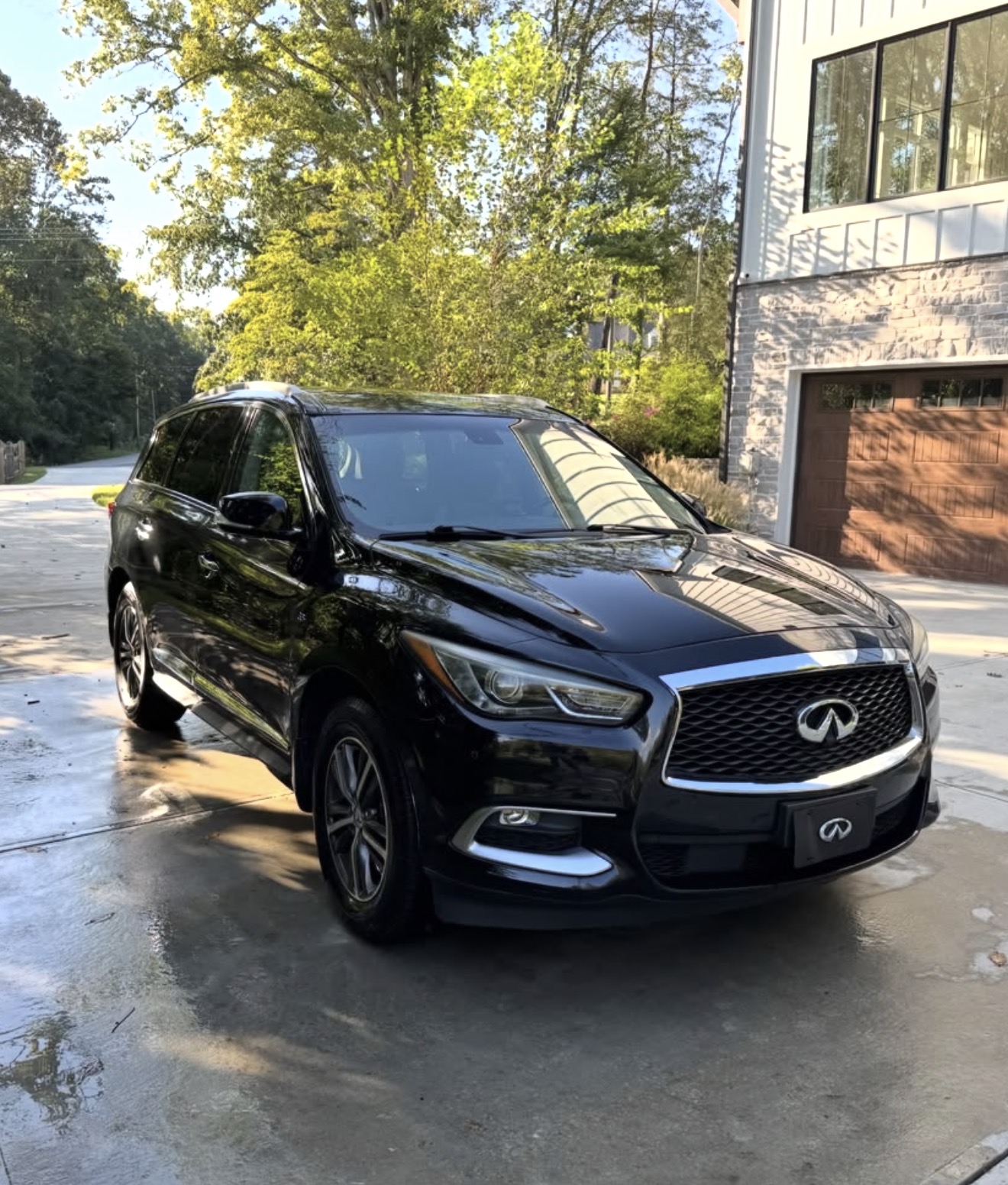 Black Infiniti QX60 gleaming after a full exterior detail