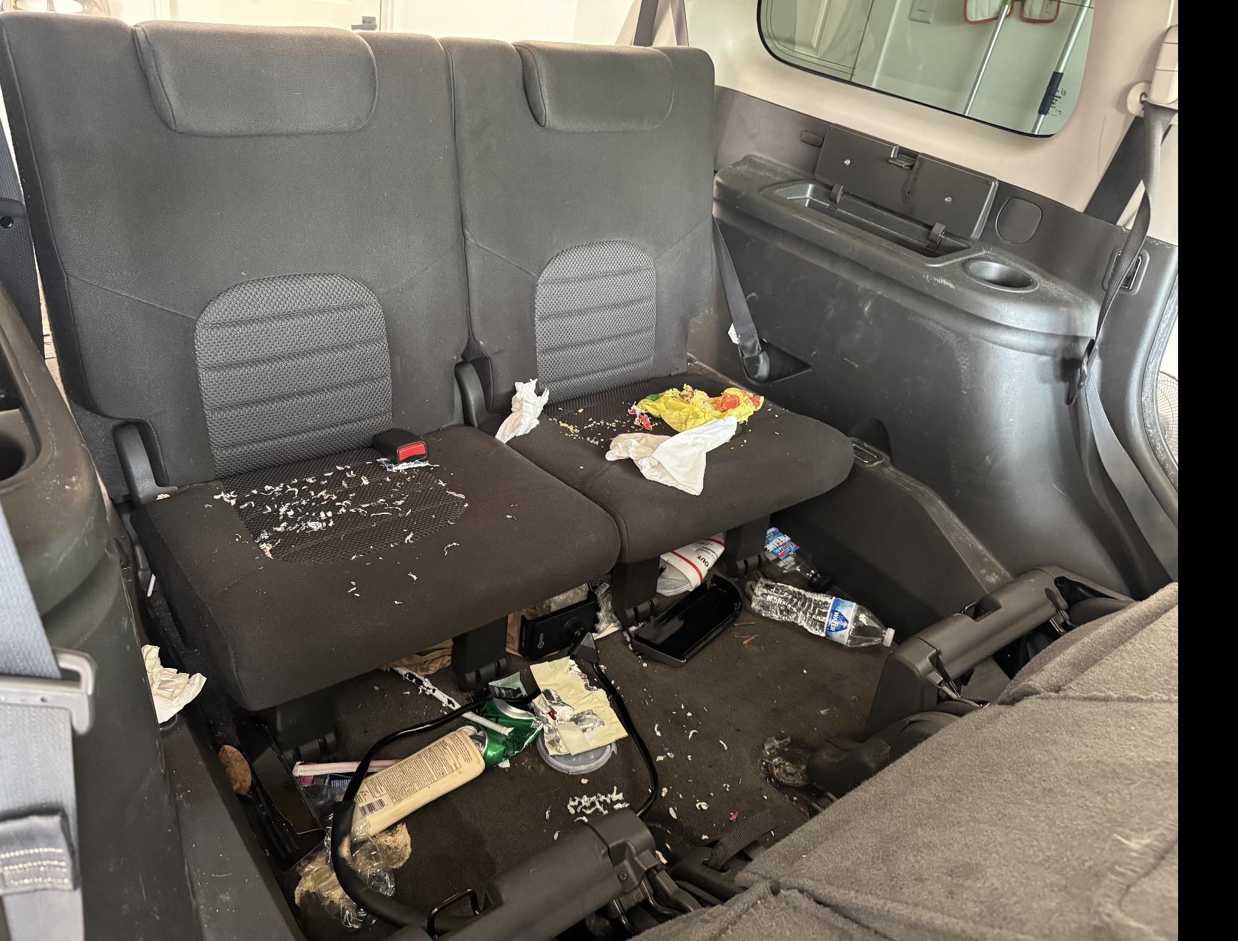 Nissan Pathfinder third row with crumbs and trash before detailing