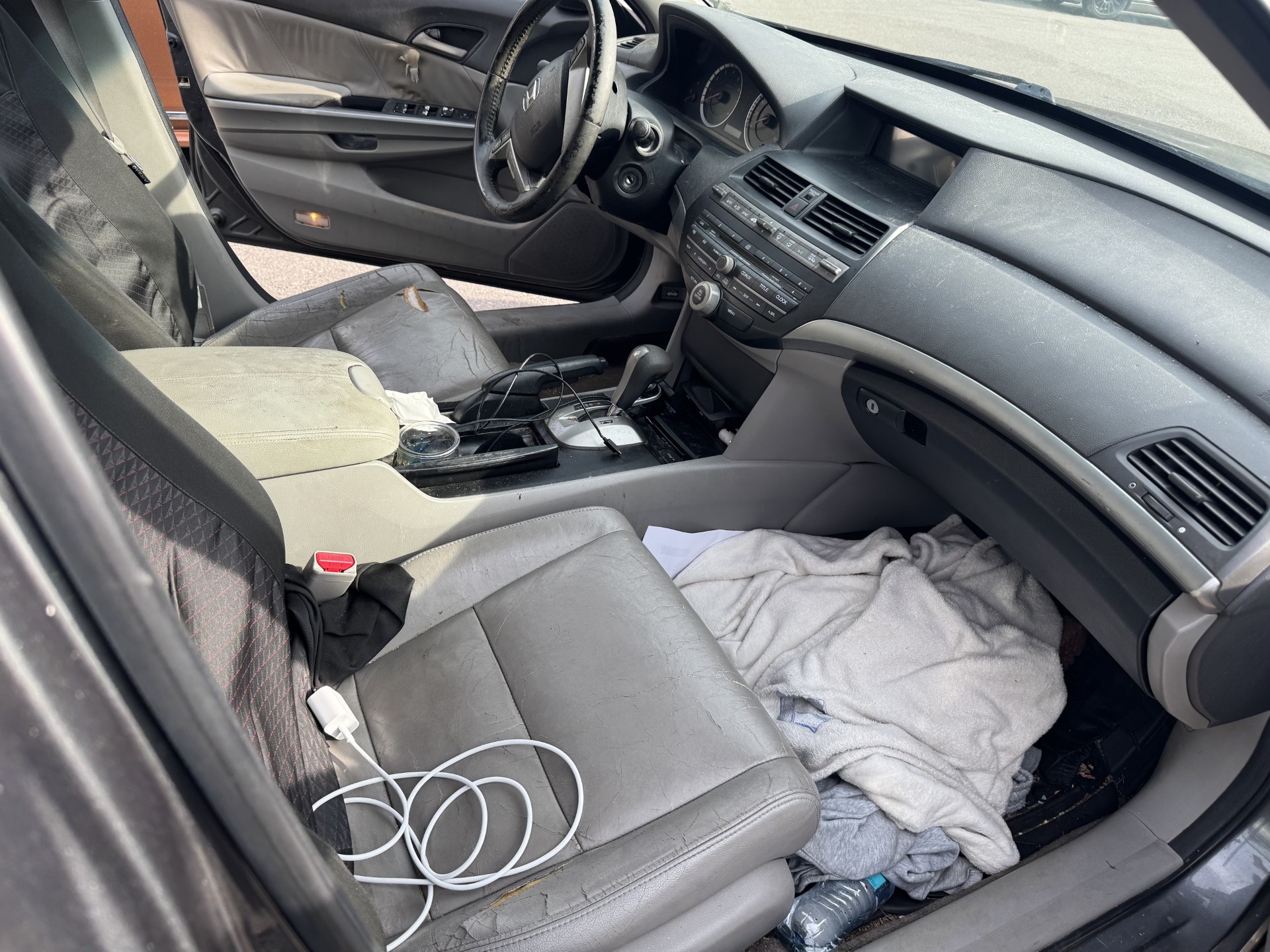 Honda Accord front seats cluttered and stained before interior detailing