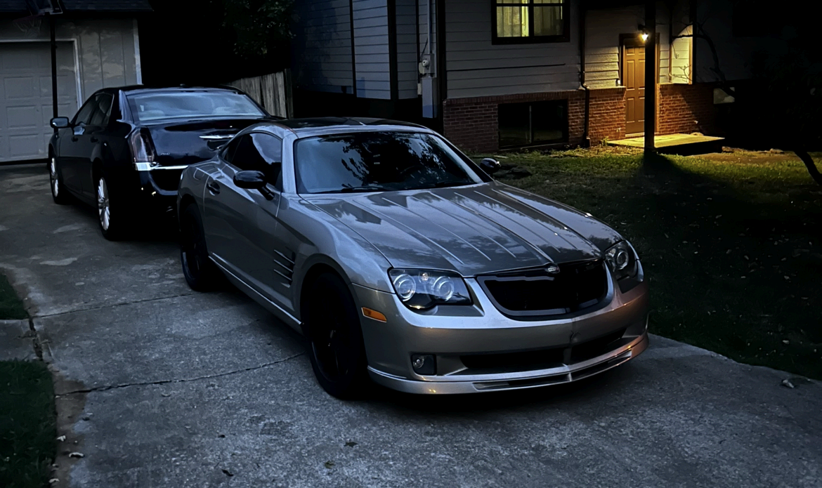 Silver Chrysler Crossfire gleaming at night after a full exterior detail