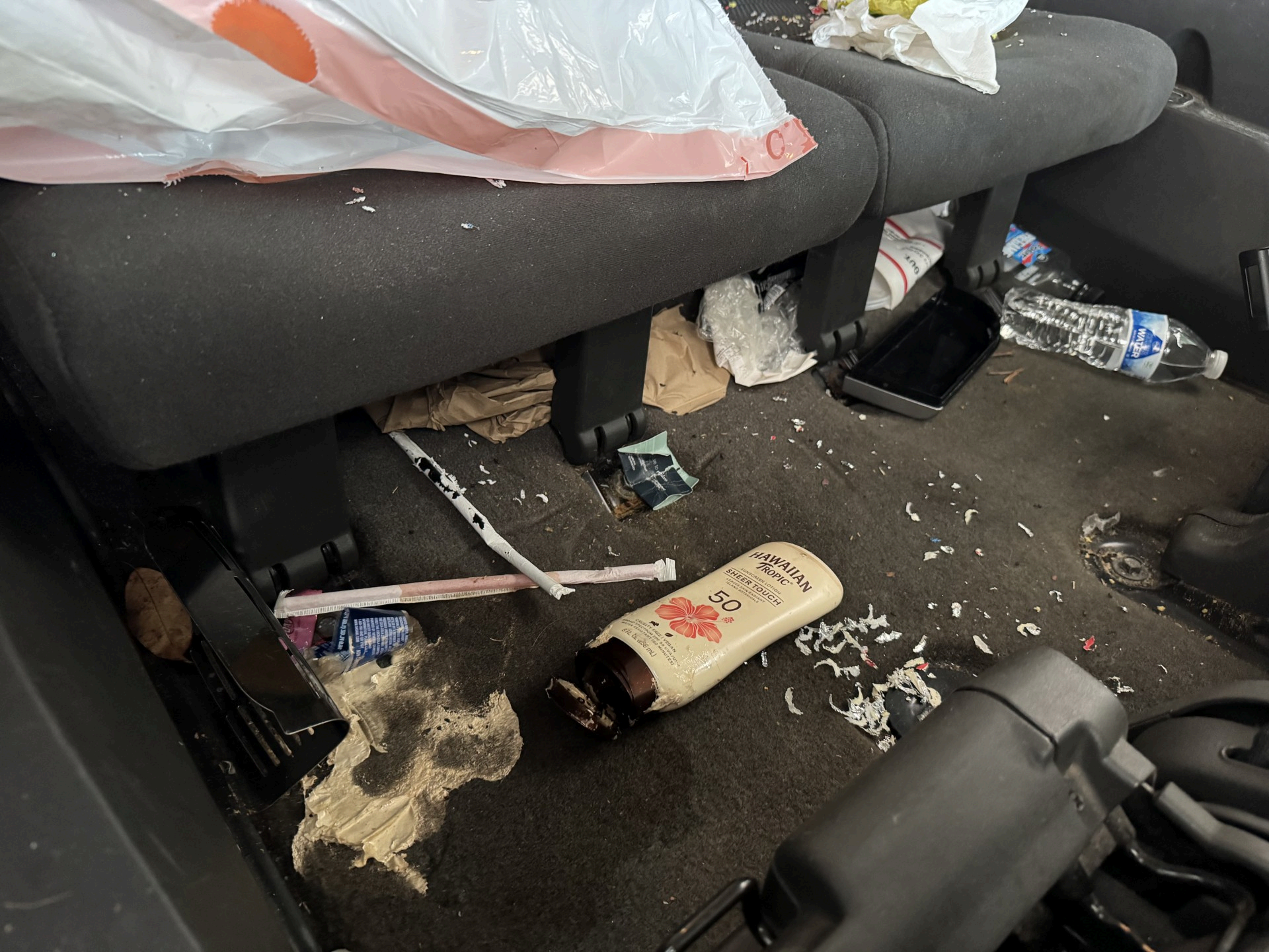 Nissan Pathfinder rear floor covered in debris before detailing