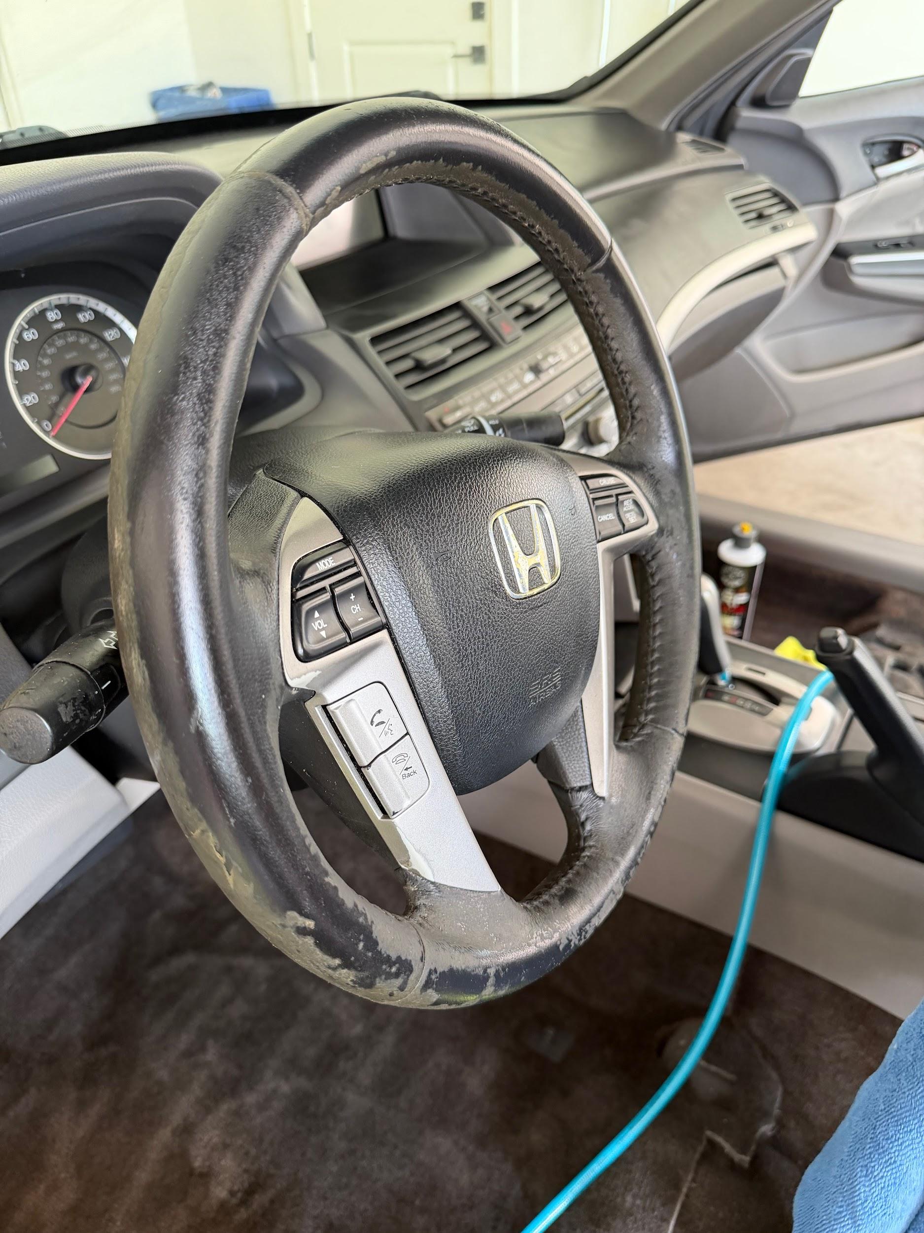 Honda Accord worn steering wheel and stained floor before cleaning